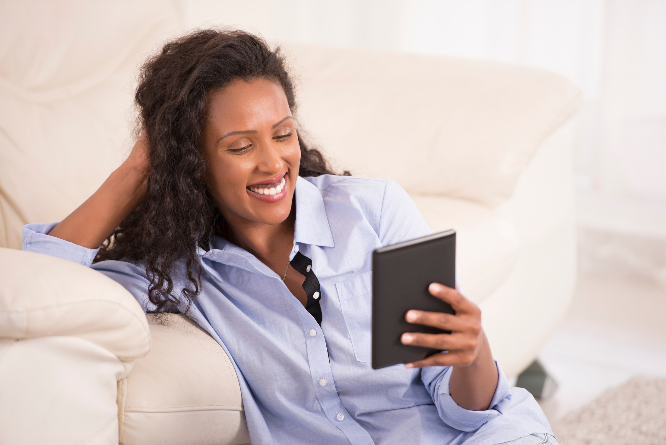 Woman reading e-reader.