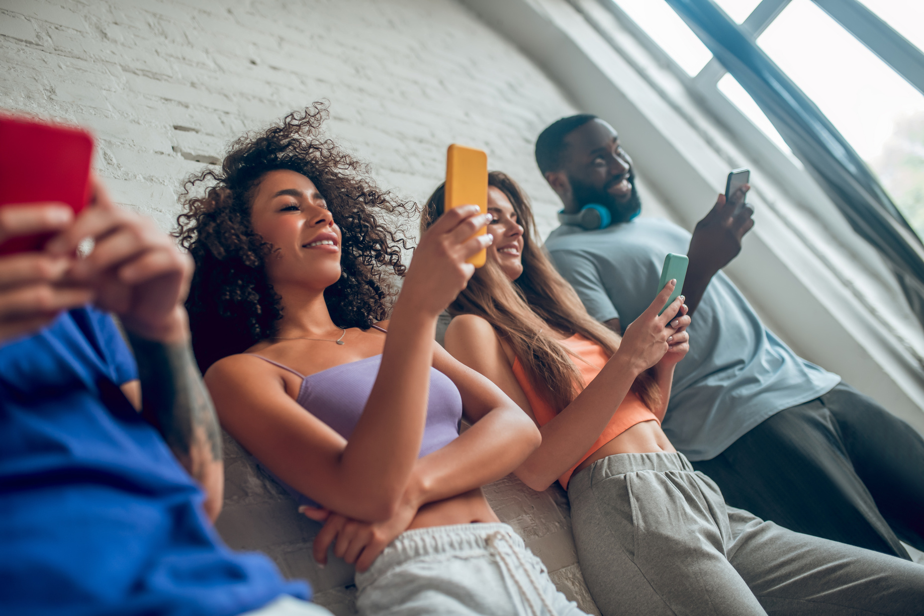 Three people scrolling their social media accounts